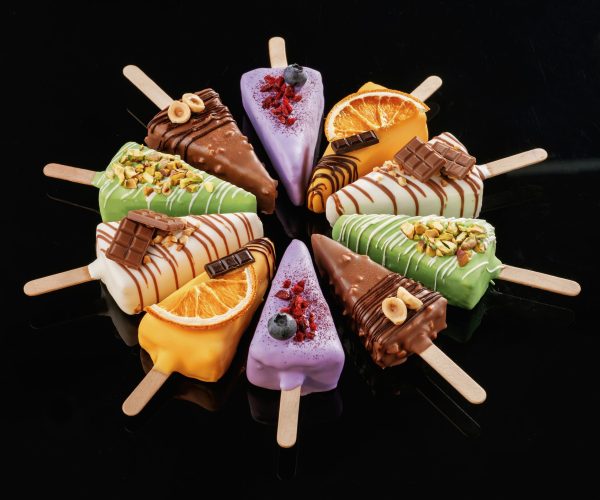 Organized on the surface. Tasty cheesecakes on the black background.